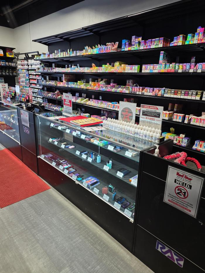Register and shelves with disposable vapes and cases with vape hardware