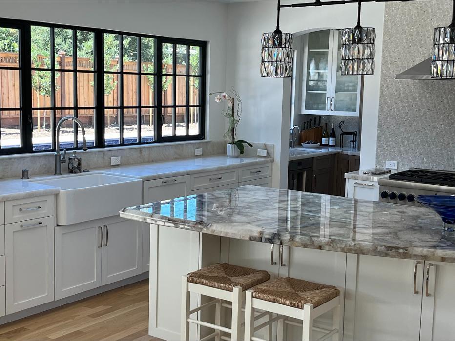 This Palo Alto kitchen renovation features Bianco quartzite countertops and an Agate Stone island, paired with white cabinetry and modern detailing.