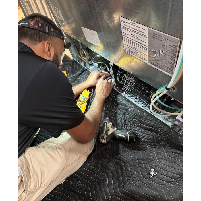 Amyan Appliance Service LLC technician performing a refrigerator repair in Seminole, FL. Our licensed experts handle appliance diagnostics and repairs with precision, keeping your home running smoothly.