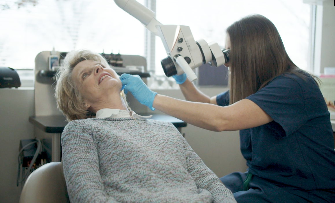 Cherie L. Booth, MD, checking a patient's ear