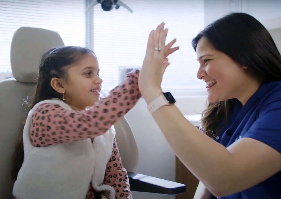 Sakeena Payne, MD, with a pediatric patient