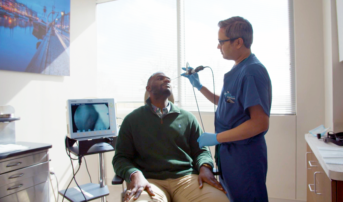 Nimish A. Patel, MD, checking a patient's nose