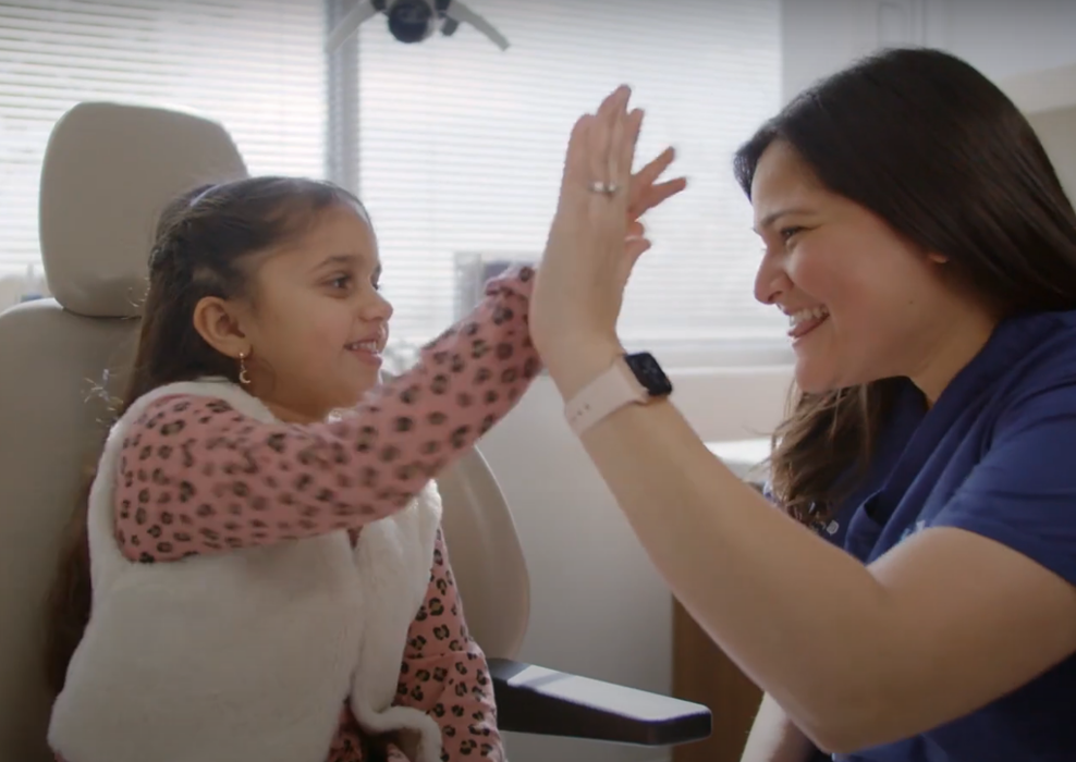 Sakeena Payne, MD, with a pediatric patient