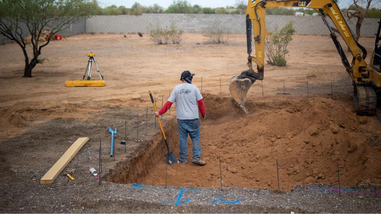 Start of a new pool build with excavation and layout. AE Outdoor Living crews preparing the dig with precise measurements.