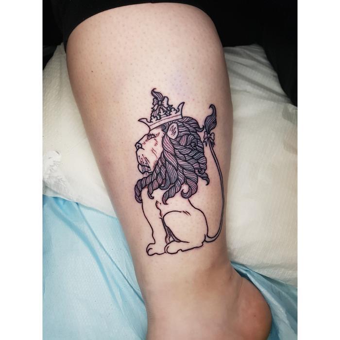 Fine line Cowardly Lion tattoo from The Wizard of Oz. Delicate linework with detailed shading.