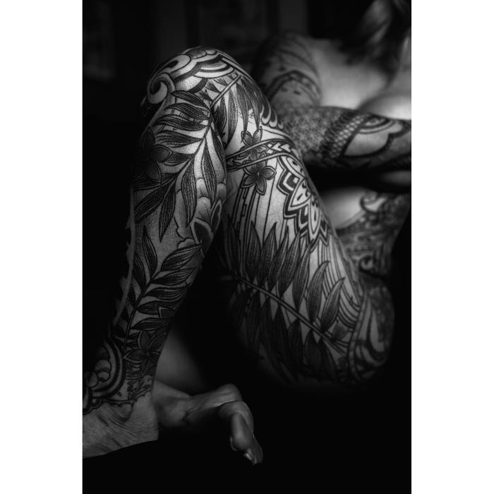 Black work body suit tattoo with Polynesian tribal and floral elements. Sleeve, torso, and leg coverage done at Red Arbor Tattoo.