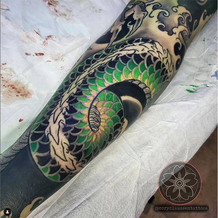 Japanese dragon tattoo by Cory. Green scales, bold waves, and traditional Japanese style with vibrant color.