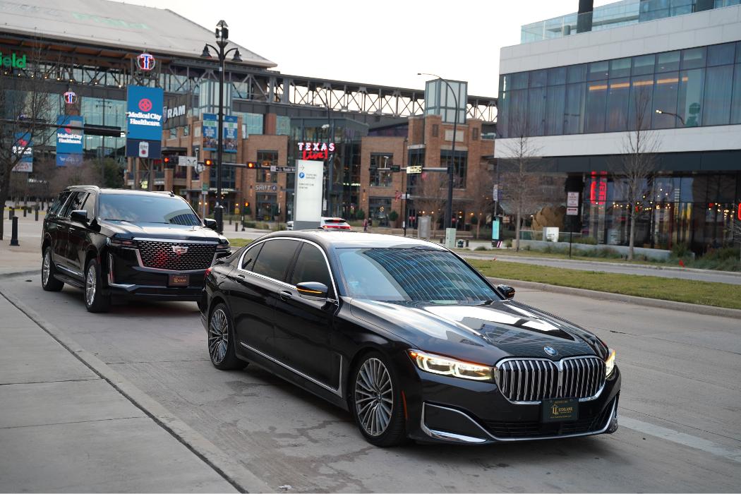 Professional chauffeur picking up passengers at the airport with luxury black car service in Dallas and Fort Worth, serving the DFW Airport area.