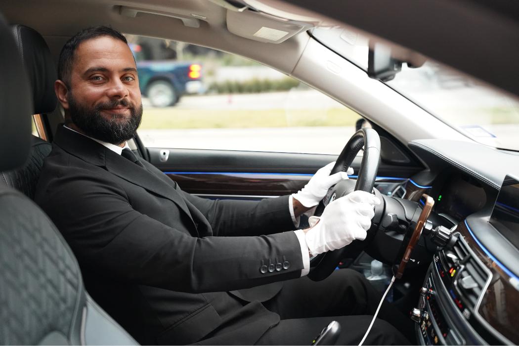 Professional chauffeur providing luxury black car transportation service for airport transfers and private rides in Dallas and Fort Worth.