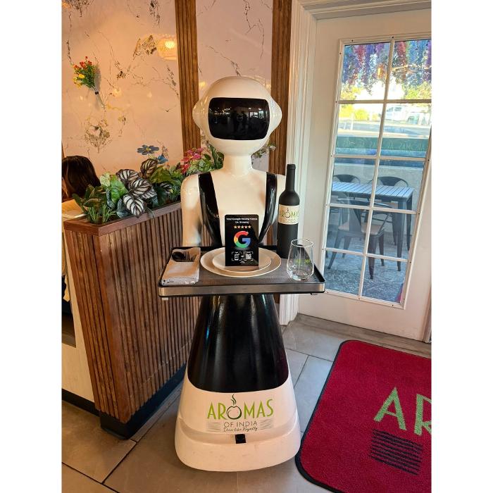 Clienity Tap NFC review stand placed inside a caf&eacute;, allowing customers to leave a Google review easily while seated.