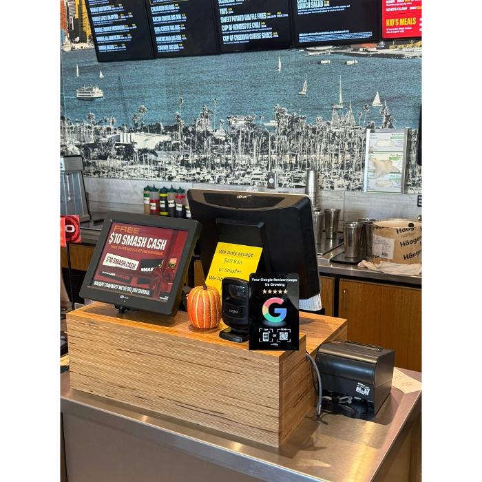 Clienity Tap NFC review stand displayed inside a local business, helping customers share their feedback through Google reviews.