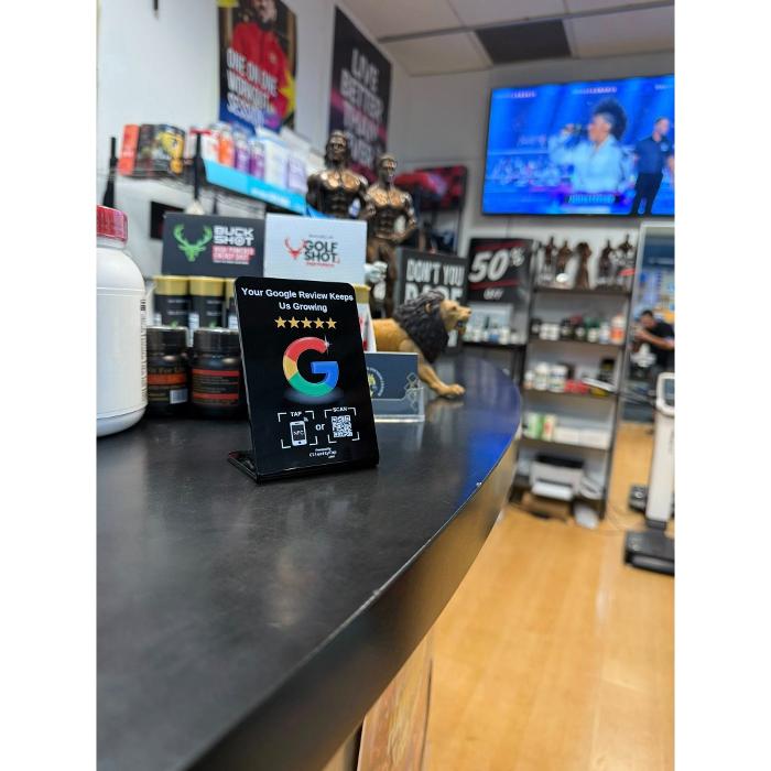 Clienity Tap NFC review stand placed inside a sporting goods store, allowing customers to easily leave a Google review with a simple phone tap.