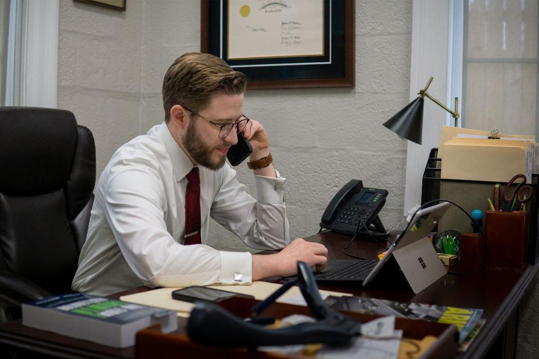 Calum Welch Yorktown VA criminal defense attorney talking with a client on the phone