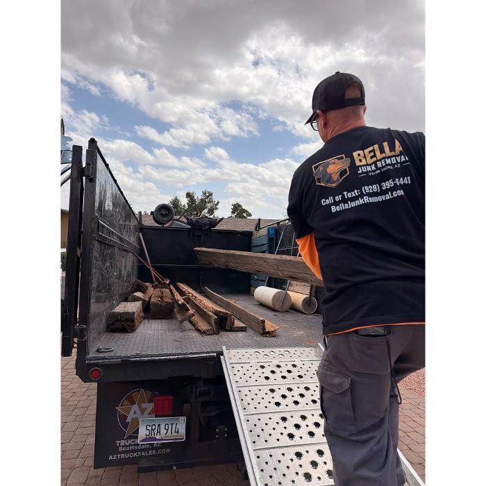 Robert hauling lumber into the dump truck.