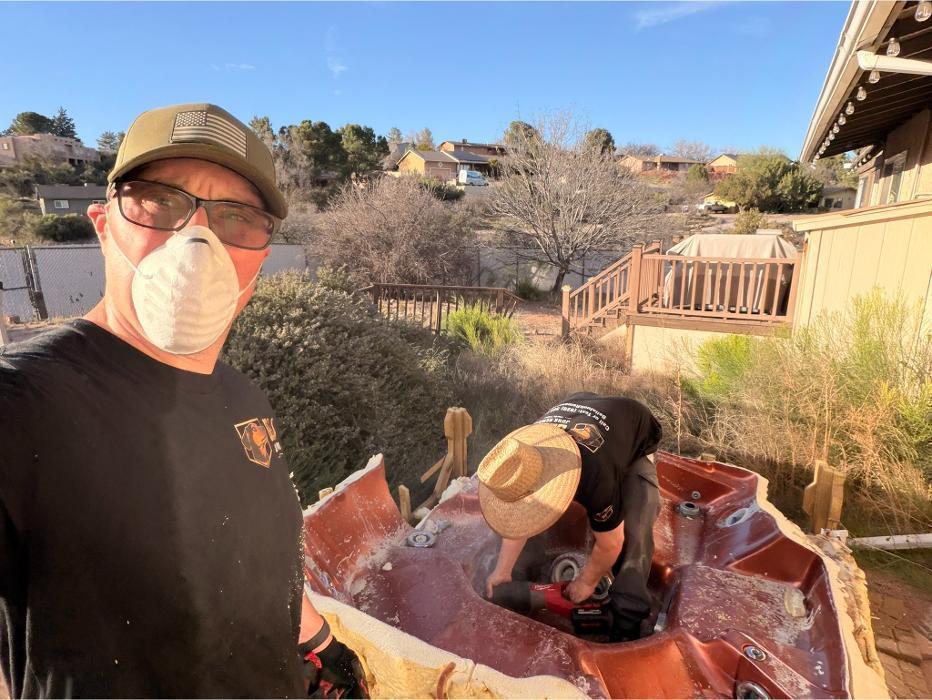 Robert cutting up a hot tub on-site for loading and hauling.