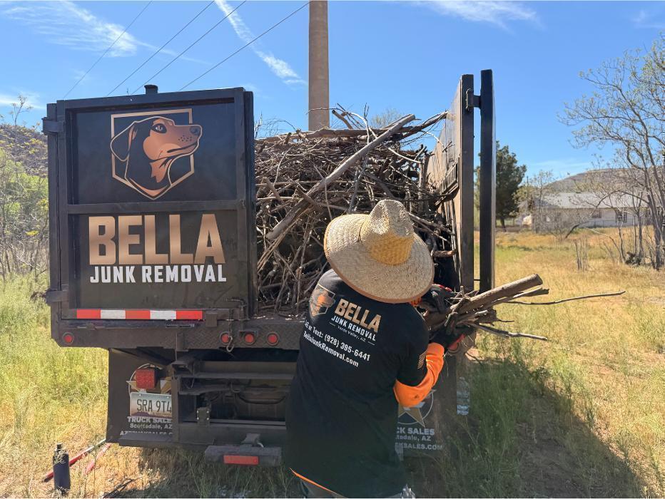 Robert tossing yard debris into the F-550 dump truck during a Verde Valley cleanup.