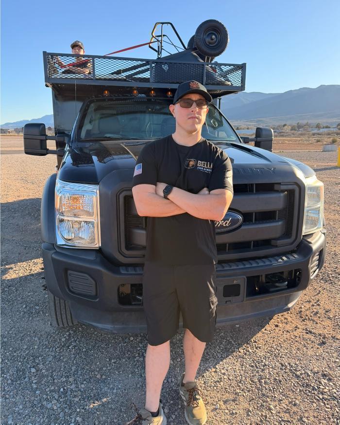 Nathaniel standing in front of the dump truck.