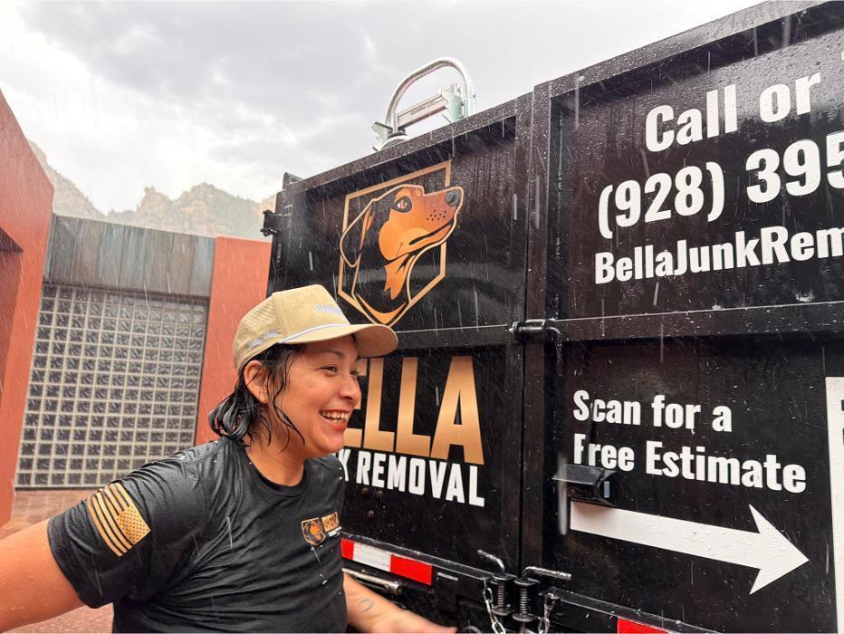 Victoria smiling in the rain in Sedona in front of the Ford F-550 dump truck.