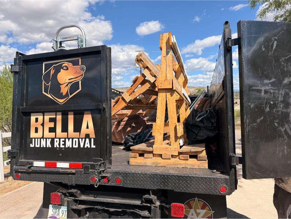 Bella Junk Removal crew removing old windows and A-frames during a construction debris removal job.