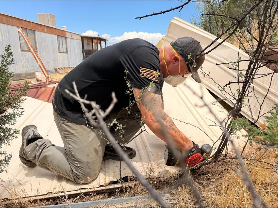 Kyle demolishing a metal shed in Rimrock, Arizona.