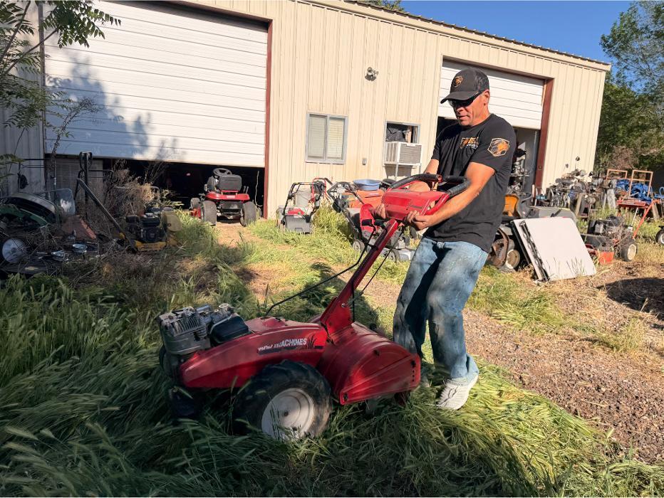 Joe hauling a tiller to the ramp for loading into the truck.