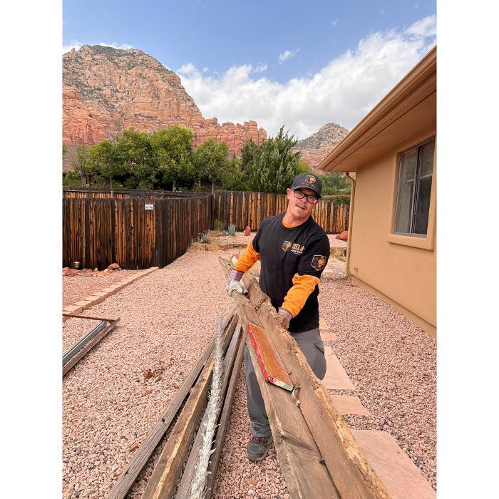 Rubber holding lumber on a junk removal job