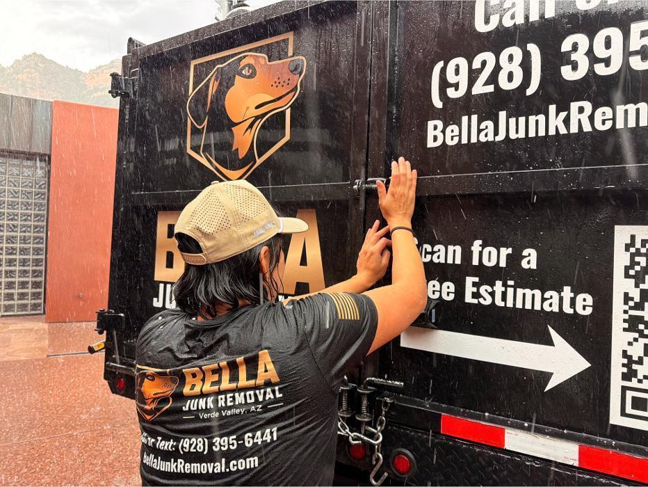 Victoria latching the doors on the dump truck.