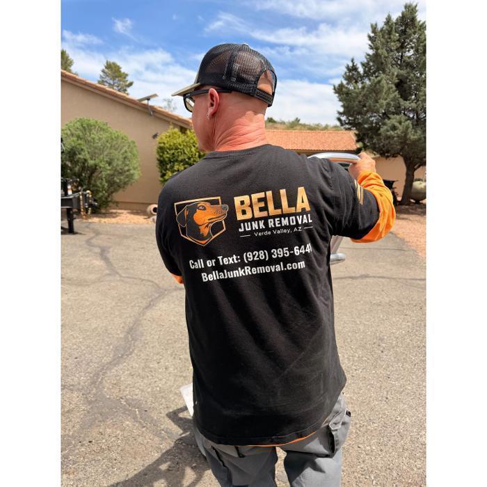 Bella Junk Removal crew member pushing a dolly to remove a refrigerator during an appliance removal job.
