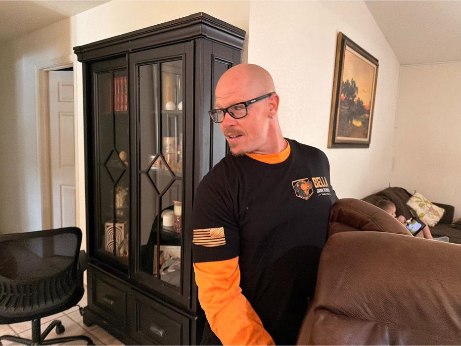 Robert is helping to carry out a recliner chair.