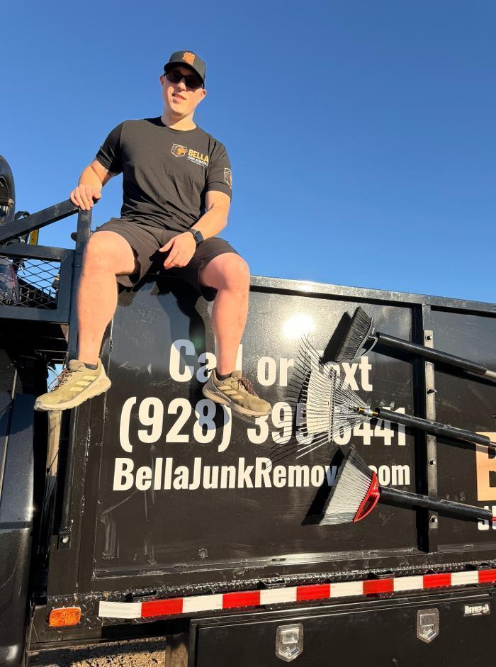 Nathaniel sitting on the side of the dump truck.