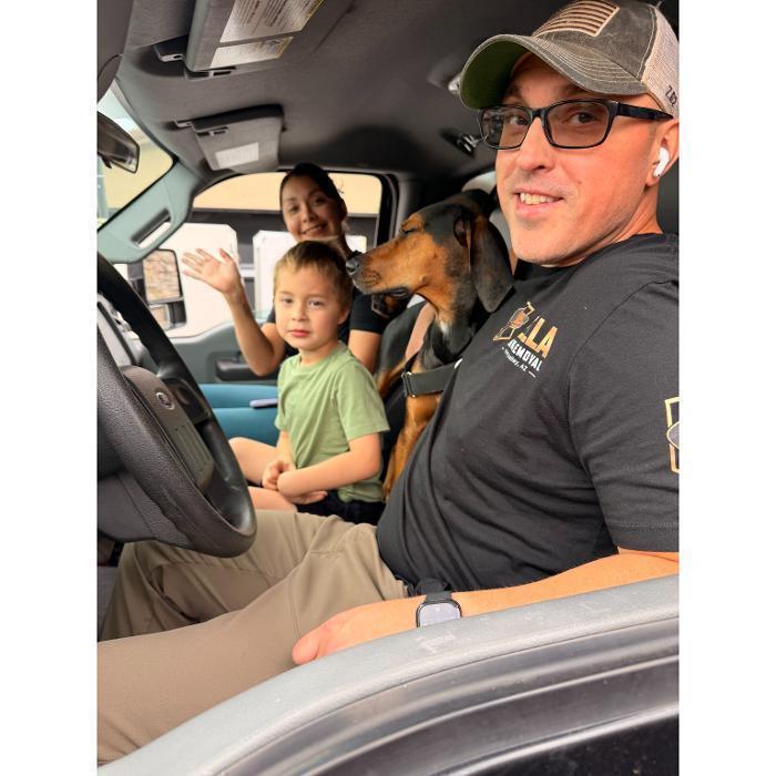 Nate, Victoria, their son Everett, and Bella the dog in the cab of the F-550.