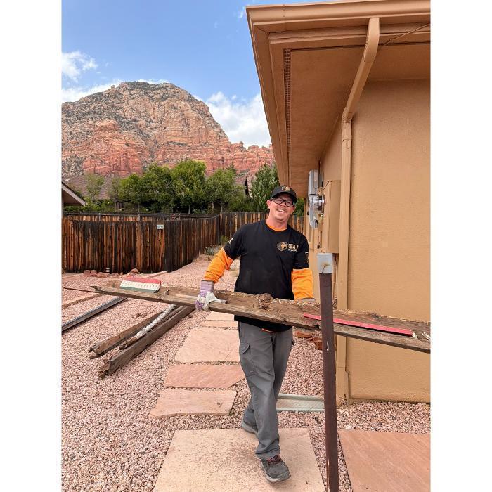 Robert hauling lumber at a junk removal job.