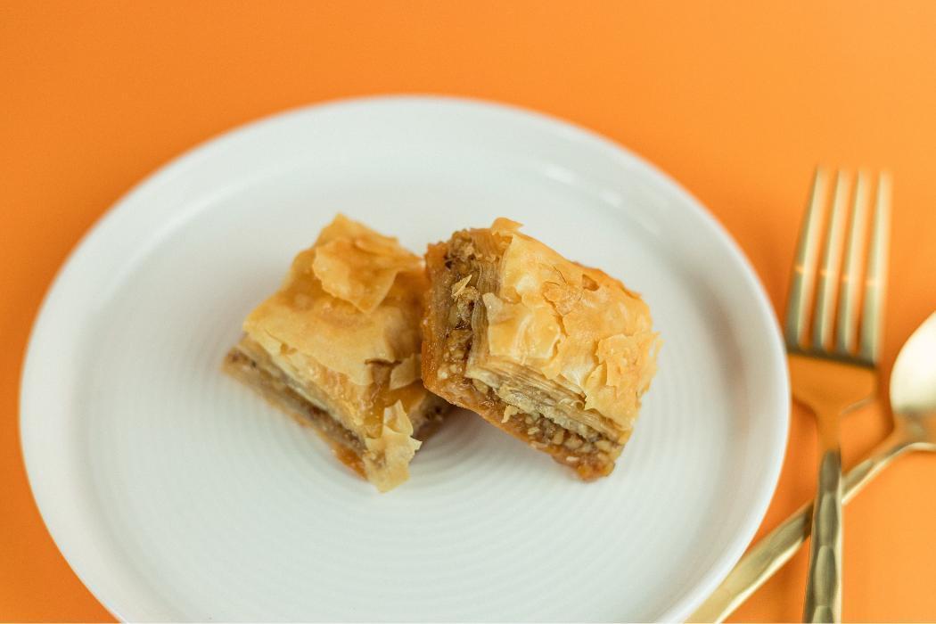 Baklava at Santorini&rsquo;s Farmington: Flaky phyllo pastry layers with nuts and honey. A sweet classic at Farmington Station!