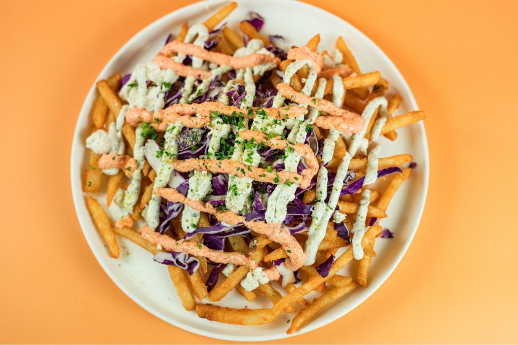 Loaded Feta Fries at Santorini's Farmington: Feta, cabbage, and lemon-herb seasoning. Spicy and delicious Mediterranean comfort food!