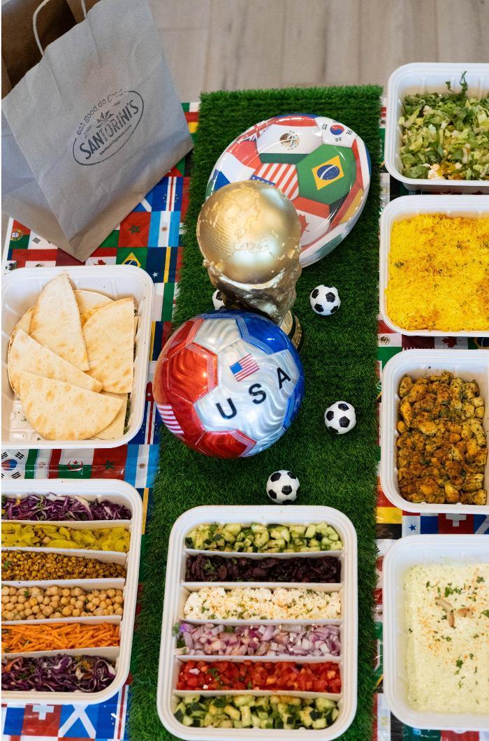 Santorini's Greek Grill catering spread with build-your-own Greek bowls, pita, hummus, and fresh toppings bar for a group event in Utah