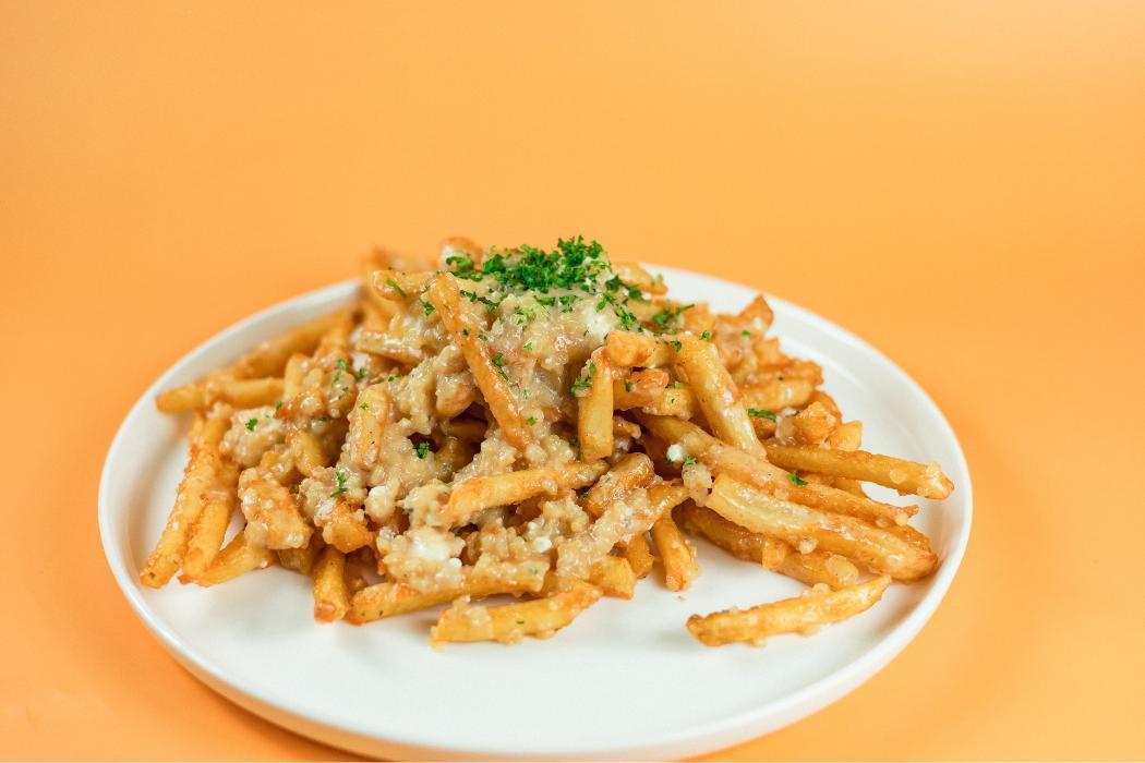 Greek Garlic Fries at Santorini's Farmington: A generous portion of garlic and feta with our House Dressing. Bold Greek flavors!