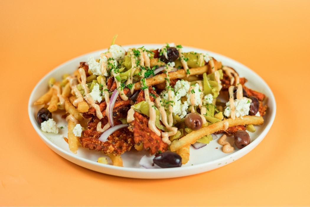 Street Cart Fries at Santorini's Farmington: Sweet potato and regular fries with feta, corn, and Doner Aioli. Our signature side!