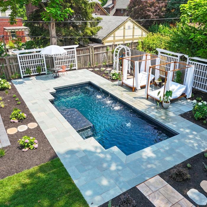 Premium Hardscaping: Precision-laid Natural stone pavers providing a clean, modern frame for the pool area.
