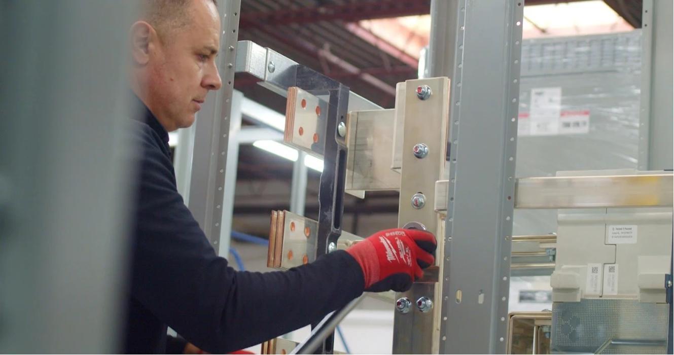 Technician assembling internal bus structure