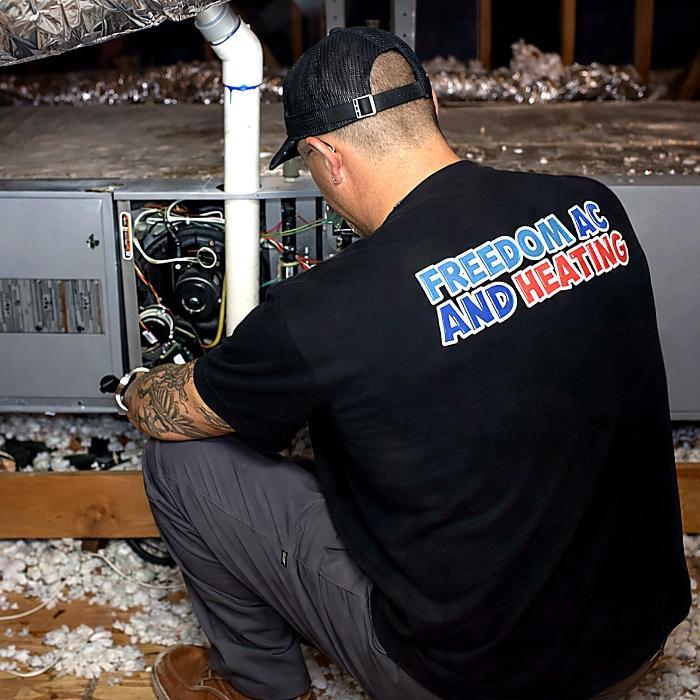 Freedom AC & Heating technician ready to help with AC and heating repair, maintenance, and installation in Orange County, CA.