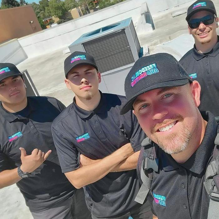 Freedom AC & Heating team on-site for commercial/residential rooftop HVAC service and maintenance in Orange County, CA.
