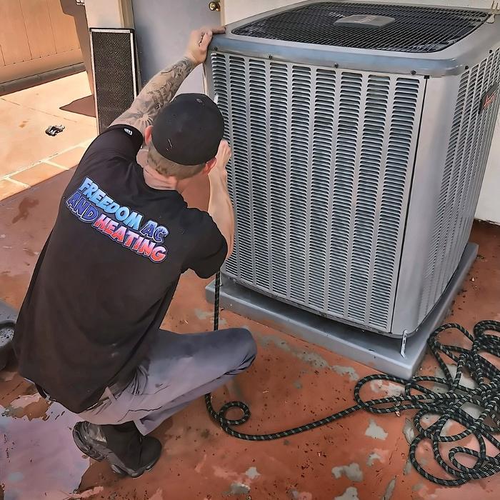 Freedom AC & Heating technician with a Bosch outdoor system after installation/service in Anaheim, CA.