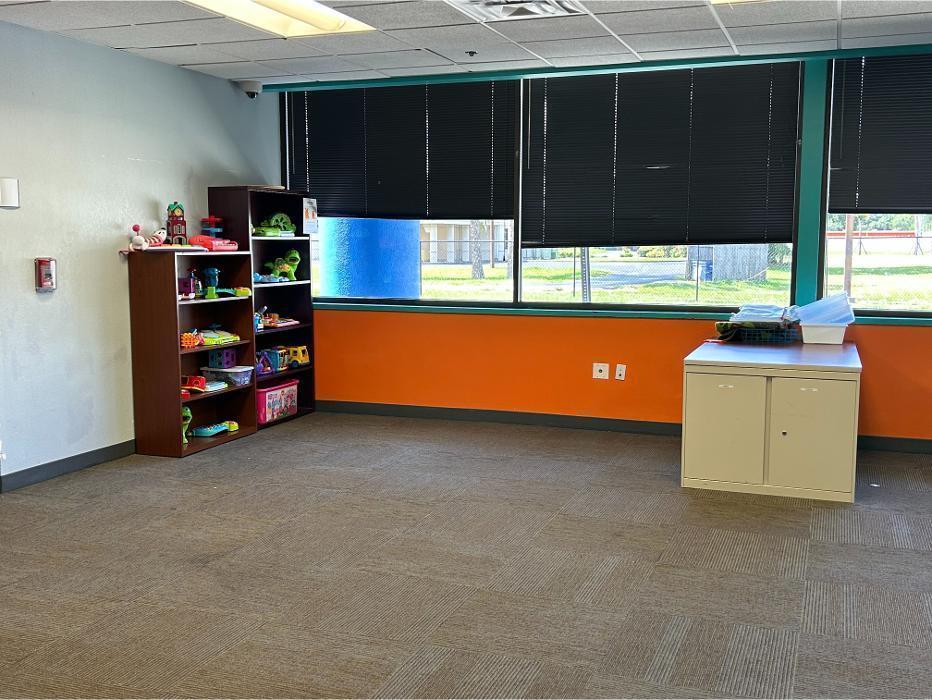 A bright classroom space at Camen Behavioral Services equipped with educational toys, organized shelving, and large windows, creating a positive environment for ABA therapy and early intervention.