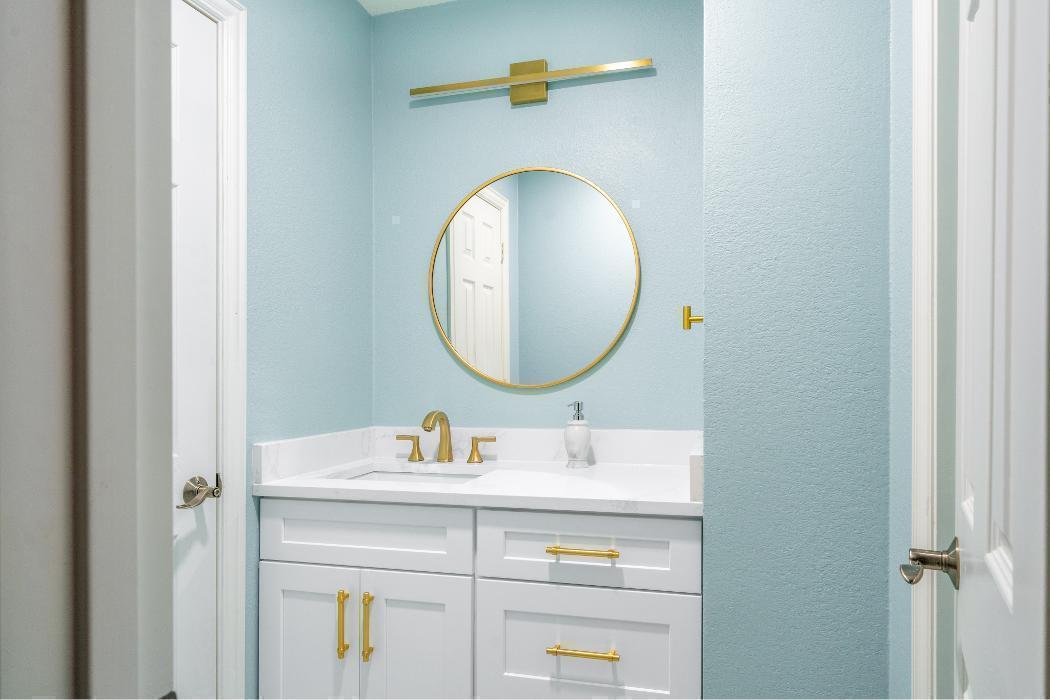Cheerful Aqua & Gold Powder Bathroom.
A compact, cheerful bathroom with a fresh and playful personality. The walls are painted a bright Robin's egg blue that immediately energizes the small space.