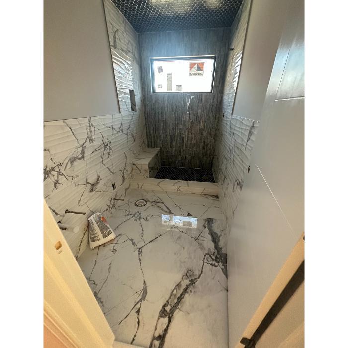 Professional floor tile installation in progress, showing precise layout, leveling, and preparation for a durable and perfectly aligned finish.