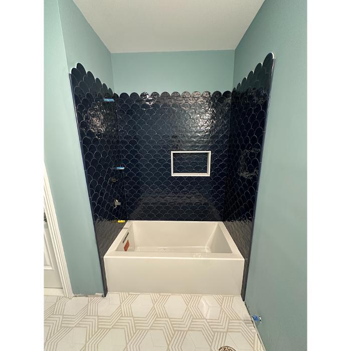 Custom bathroom tile installation featuring large format tiles and precise finishing for a modern and durable shower space.