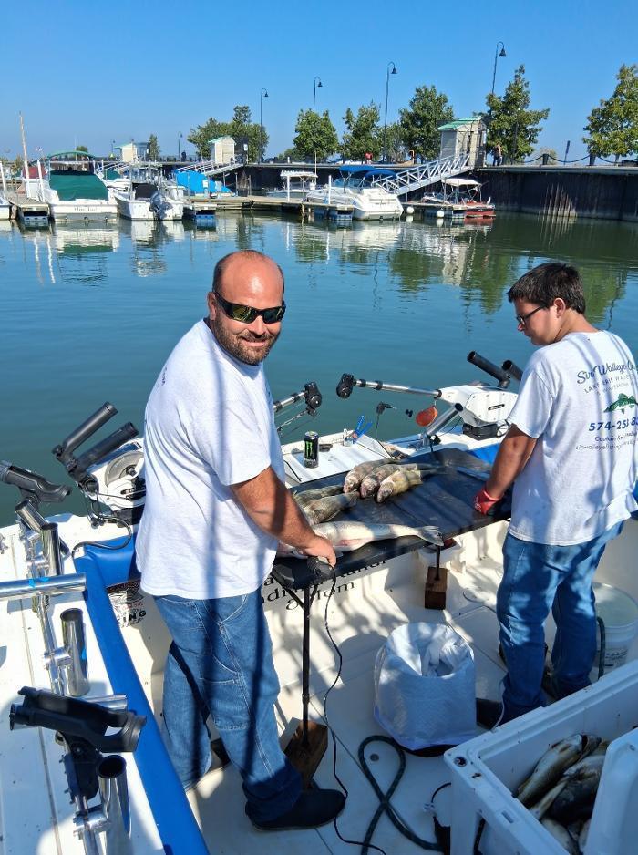 Cleaning our happy clients Lake Erie fishing charter catch!