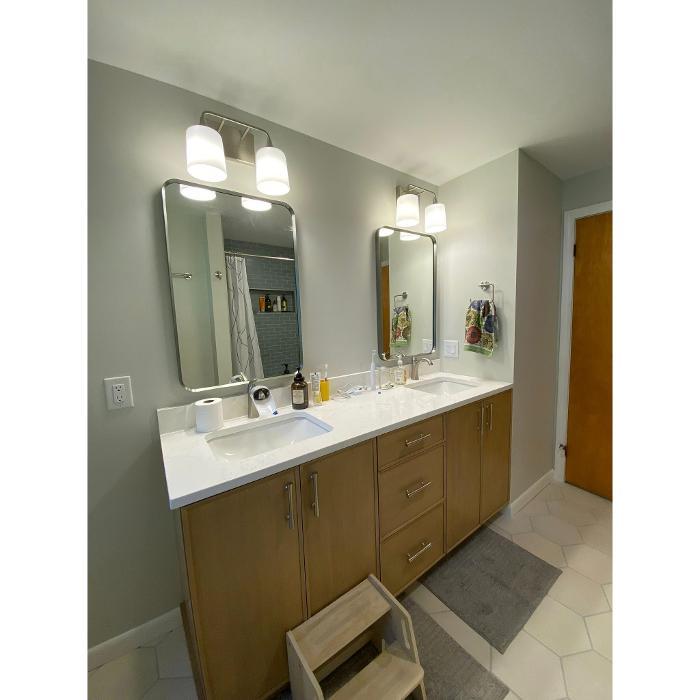 Modern bathroom remodel featuring custom cabinetry, double sink vanity, LED mirror lighting, and a clean contemporary design completed by Park Interiors .