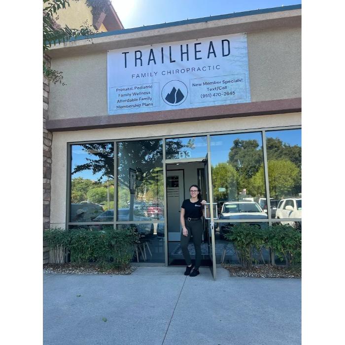 Trailhead Family Chiropractic Doctor standing at the front door of the Temecula location with new signage
