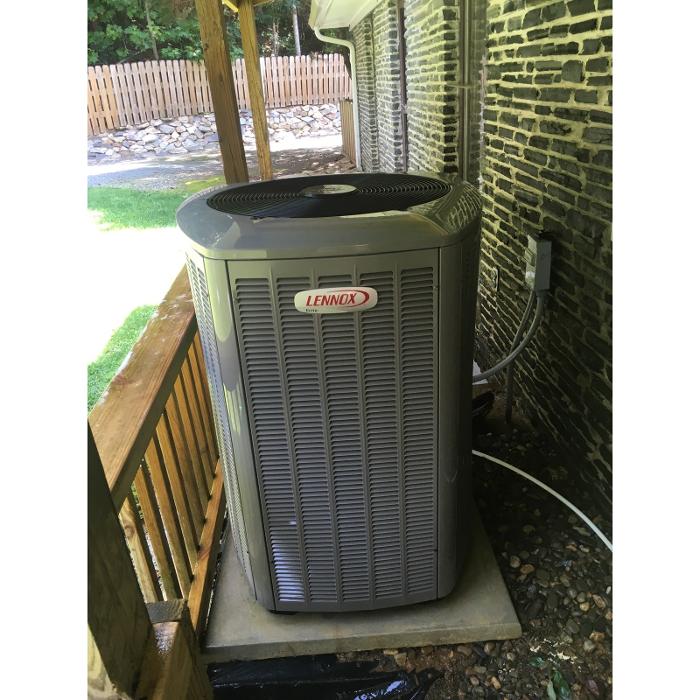 Outdoor HVAC unit installed beside a home, highlighting residential heating and cooling equipment.